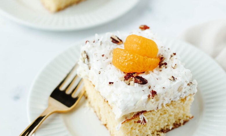 a white plate with a serving of dump cake with vanilla ice-cream on top.
