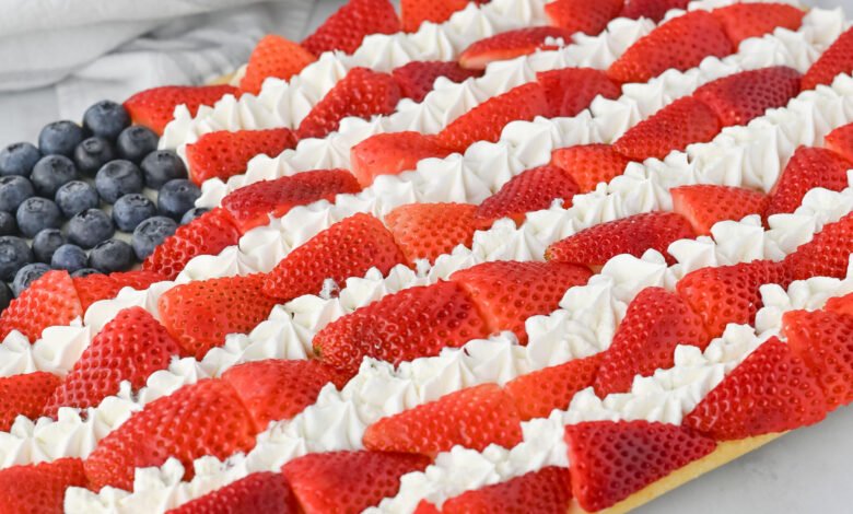 red, white, and blue sand sugar cookie balls in a paper cup.
